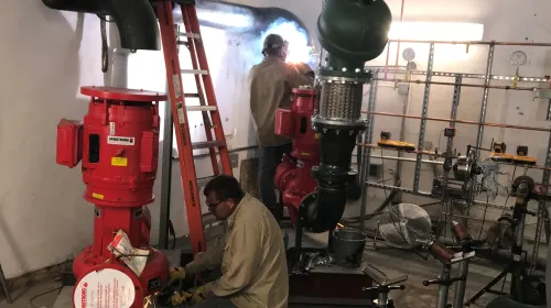 Workers put together water pump installation