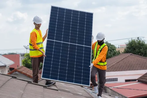 two men handling solar panels